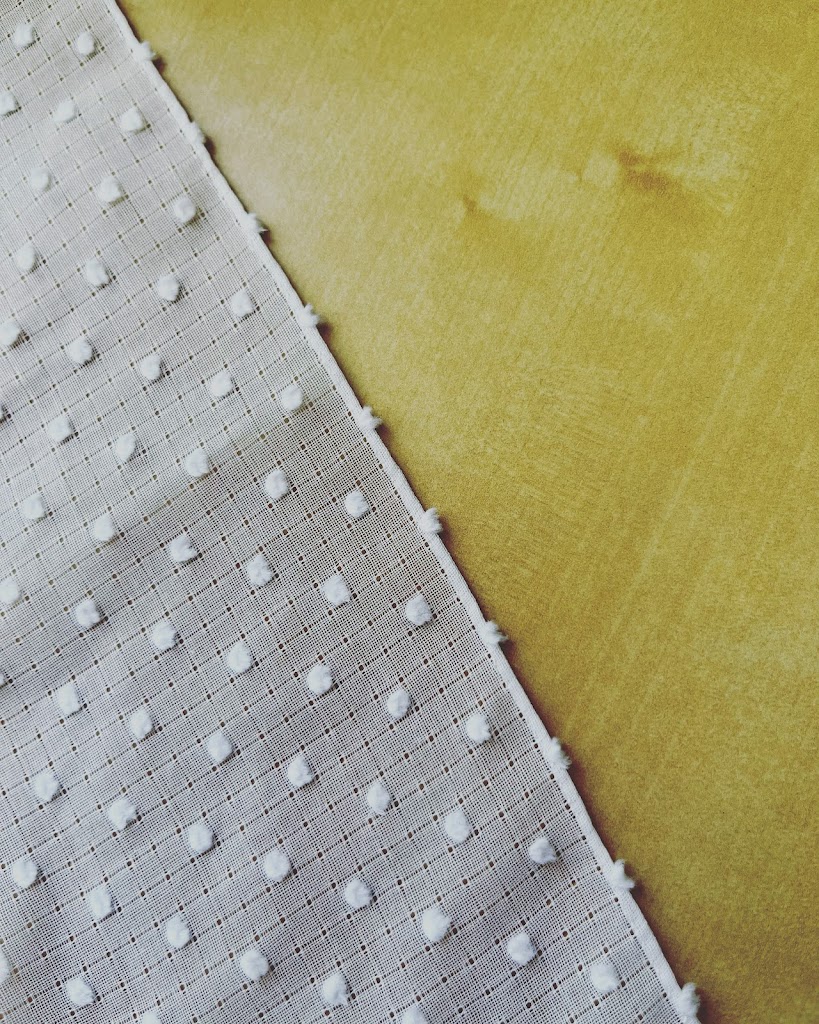 Close-up imaged of a rolled hem on a piece of white swiss cotton.
