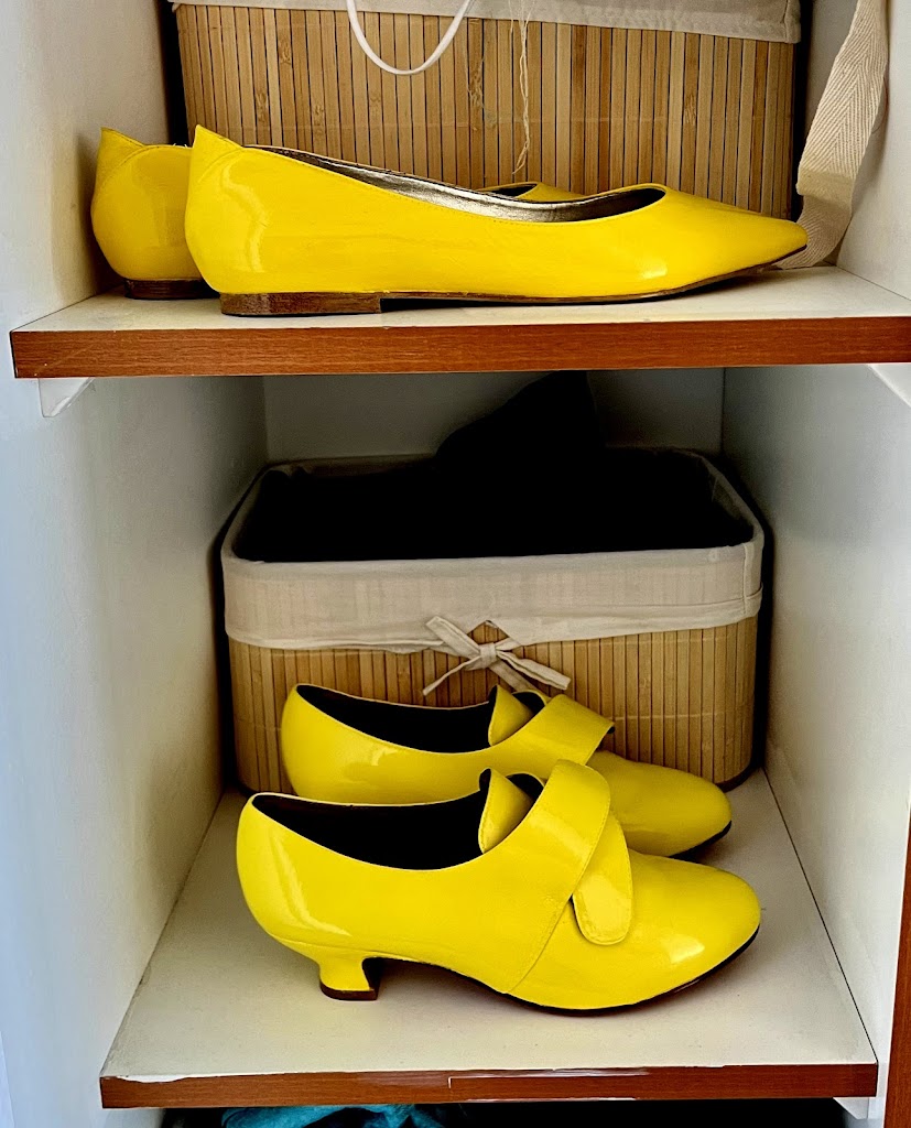 Two pairs of bright yellow painted shoes - top, 1790s slippers, bottom 1760s American Duchess Kensingtons. The paint is very shiny and they glow like disco balls under a spotlight.