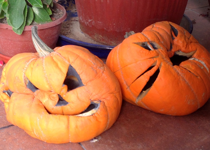 two squashed halloween pumpkins