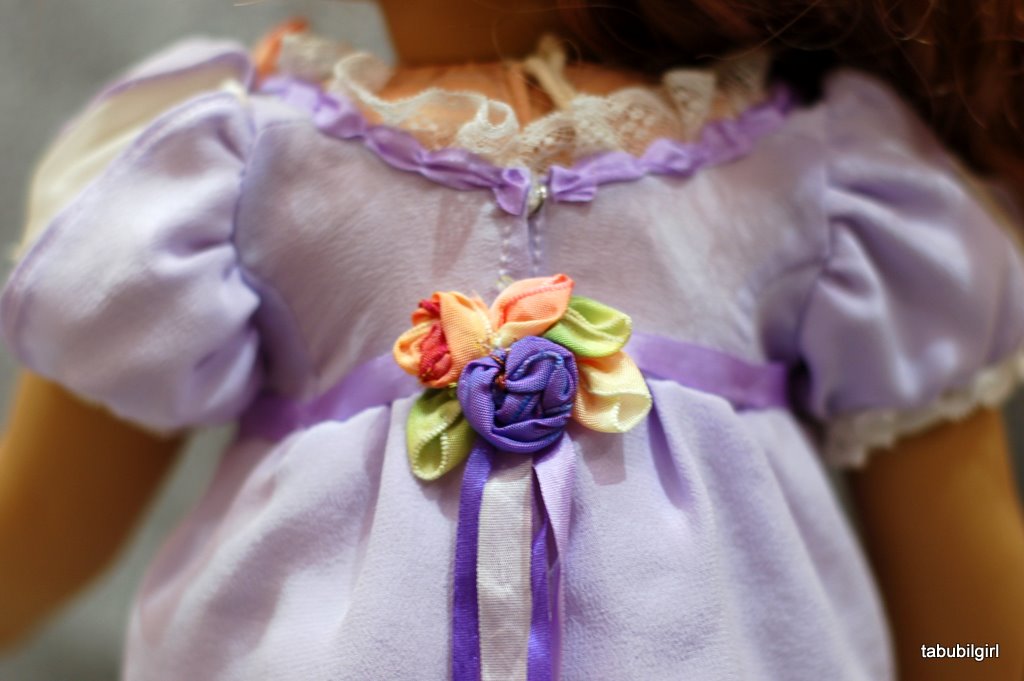 Close-up view of wired ribbon flowers at the back waist of an American Girl doll regency ballgown