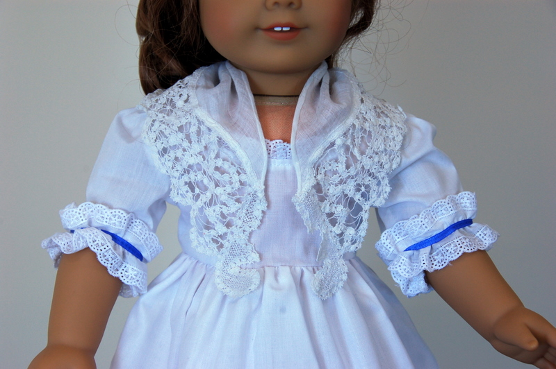An American Girl Doll wearing an 18th Century lace trimmed kerchief 