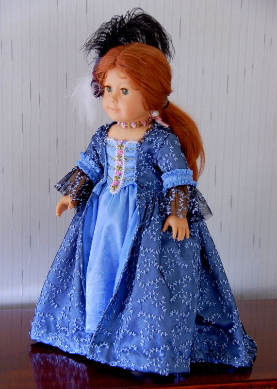  A3/4 view of an american girl doll wearing a blue rococo dress