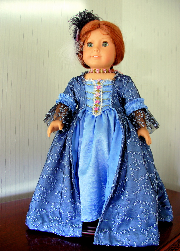 Front view of an American Girl Doll wearing a rococo gown