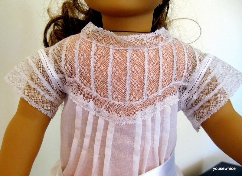 Close-up view of a doll bodice made of stitched rows of insertion lace