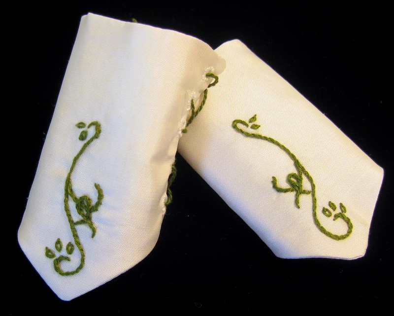A pair of white silk mitts for an American Girl doll