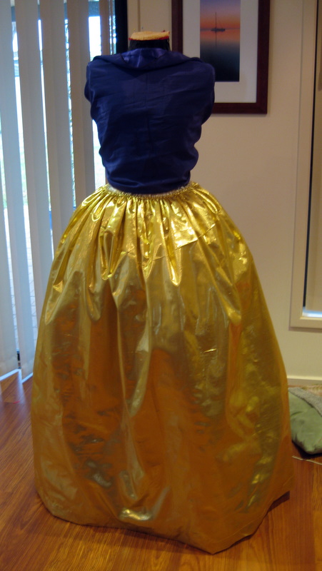 a large gold petticoat is mounted on a mannequin