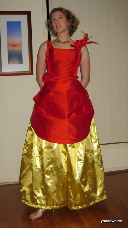Tabubilgirl poses in a fire red and gold ballgown.