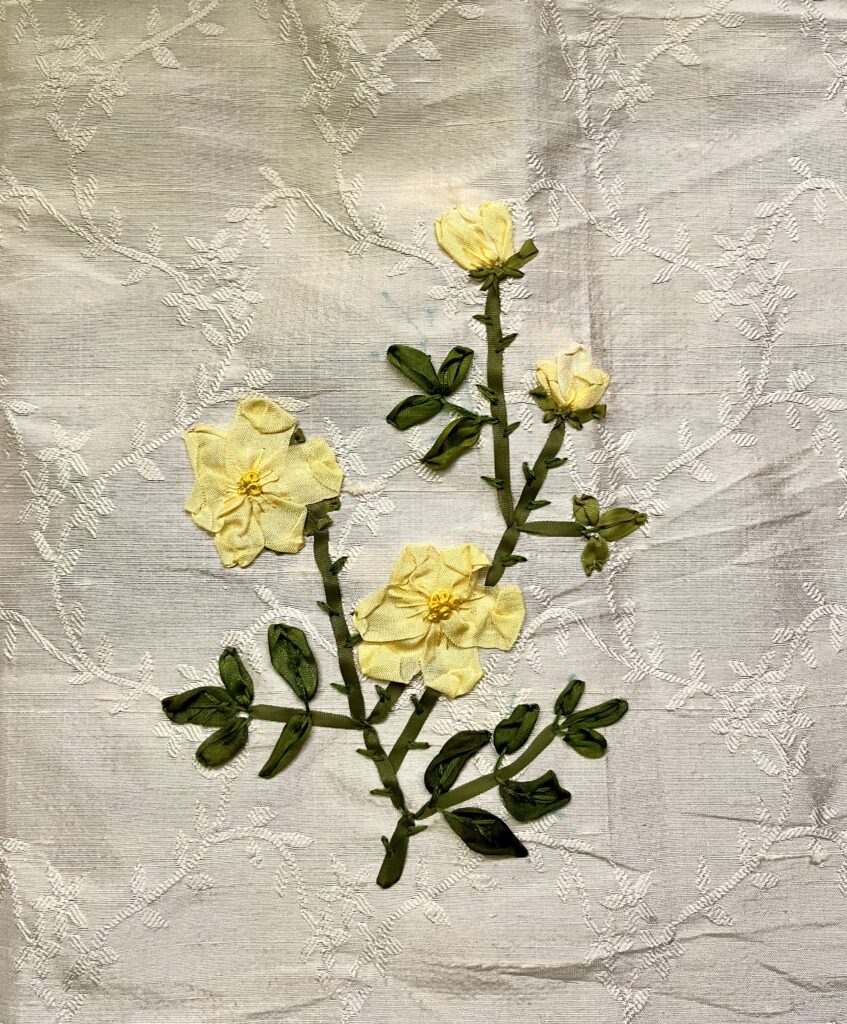 yellow roses embroidered on peach silk with pink silk ribbons