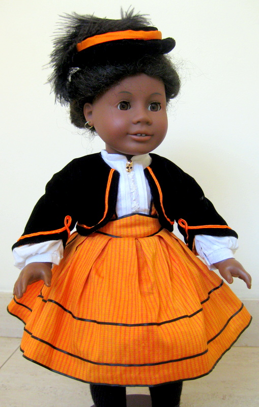 American Girl doll Addy wears an orange and black 1860s ensemble