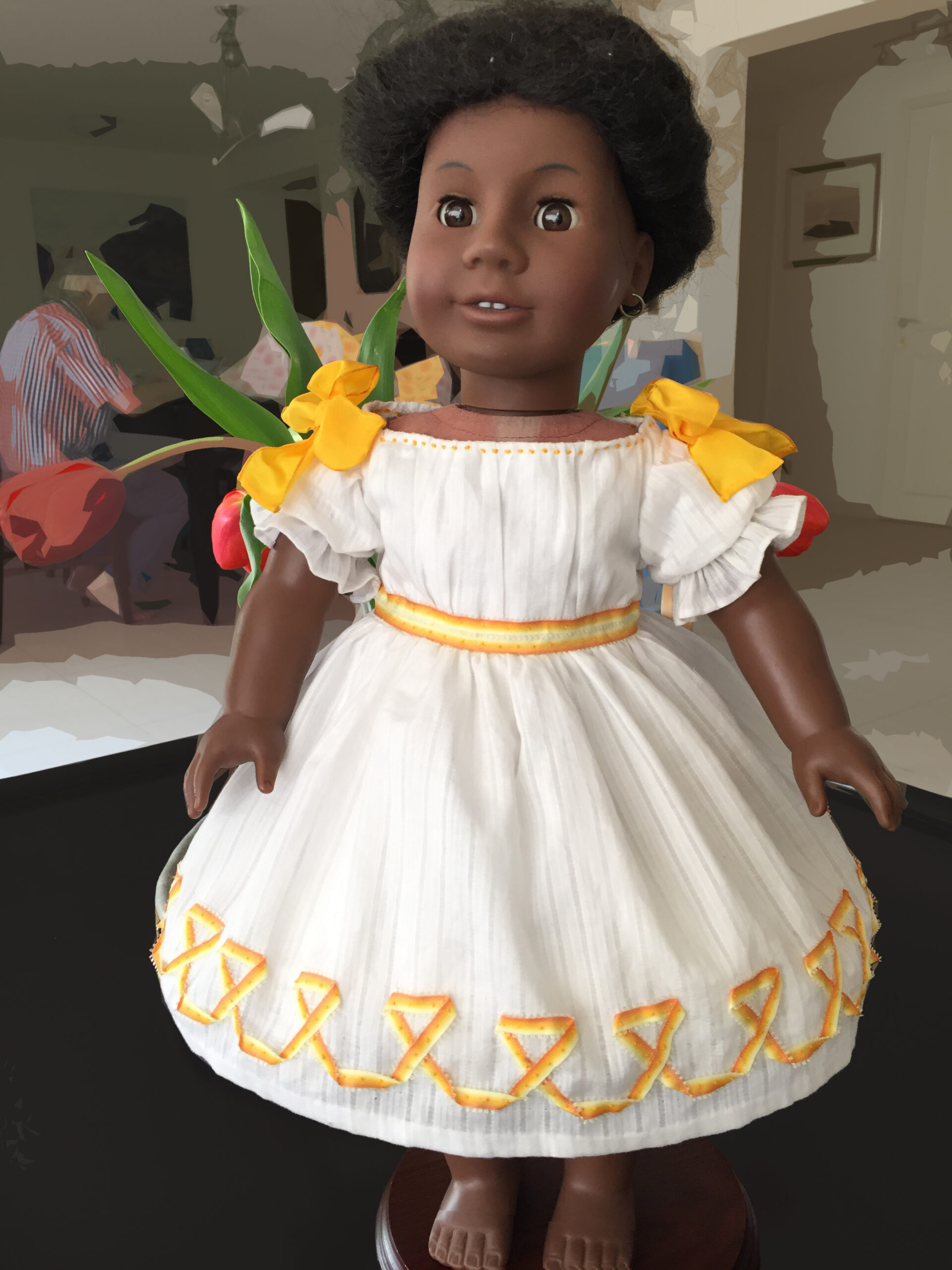 An American Girl doll wearing a white Victorian Winterhalter dress.