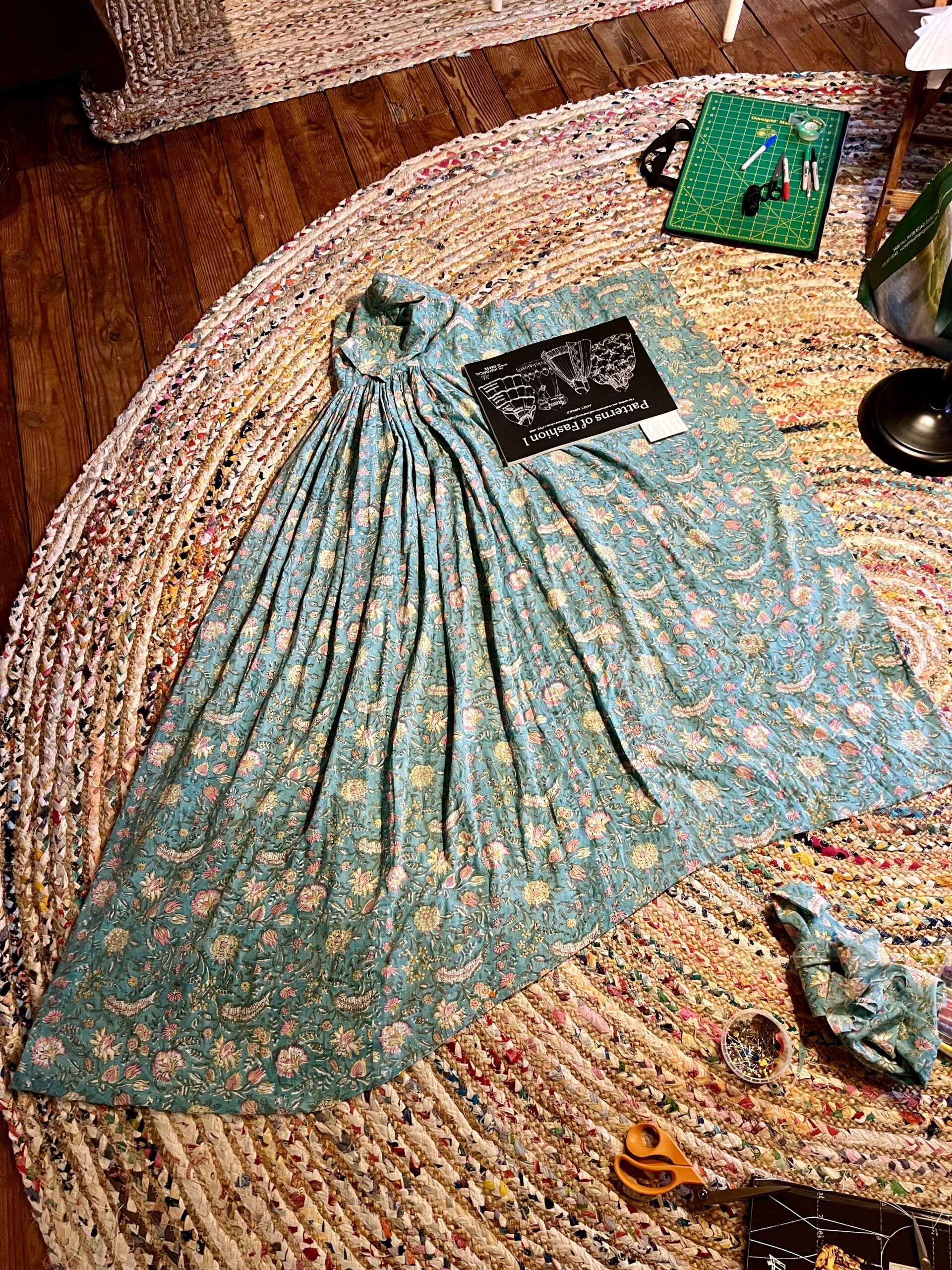 A 1790s round gown lies spread out on the floor