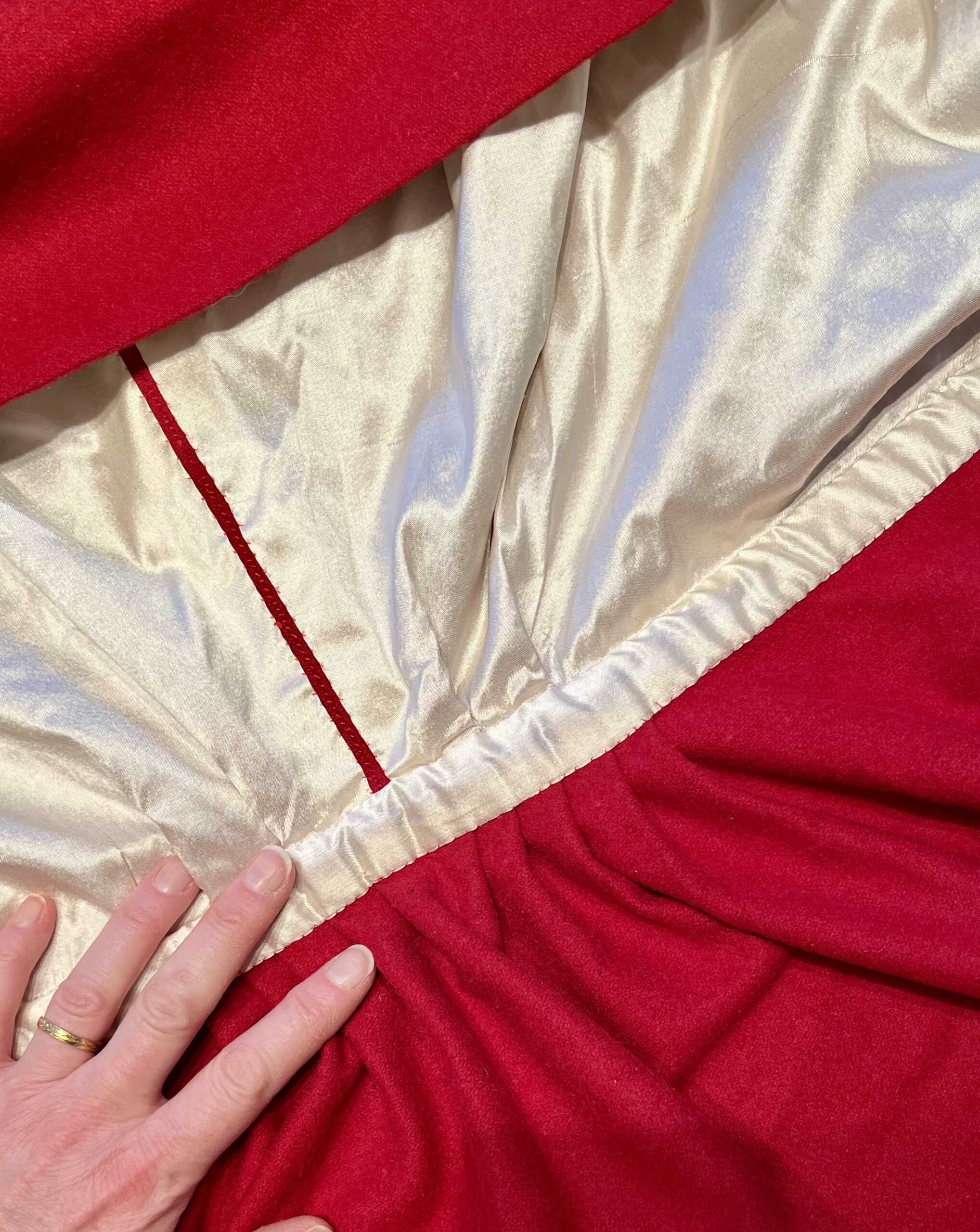Close up of the silk neckband of a red 18th century cardinal cloak