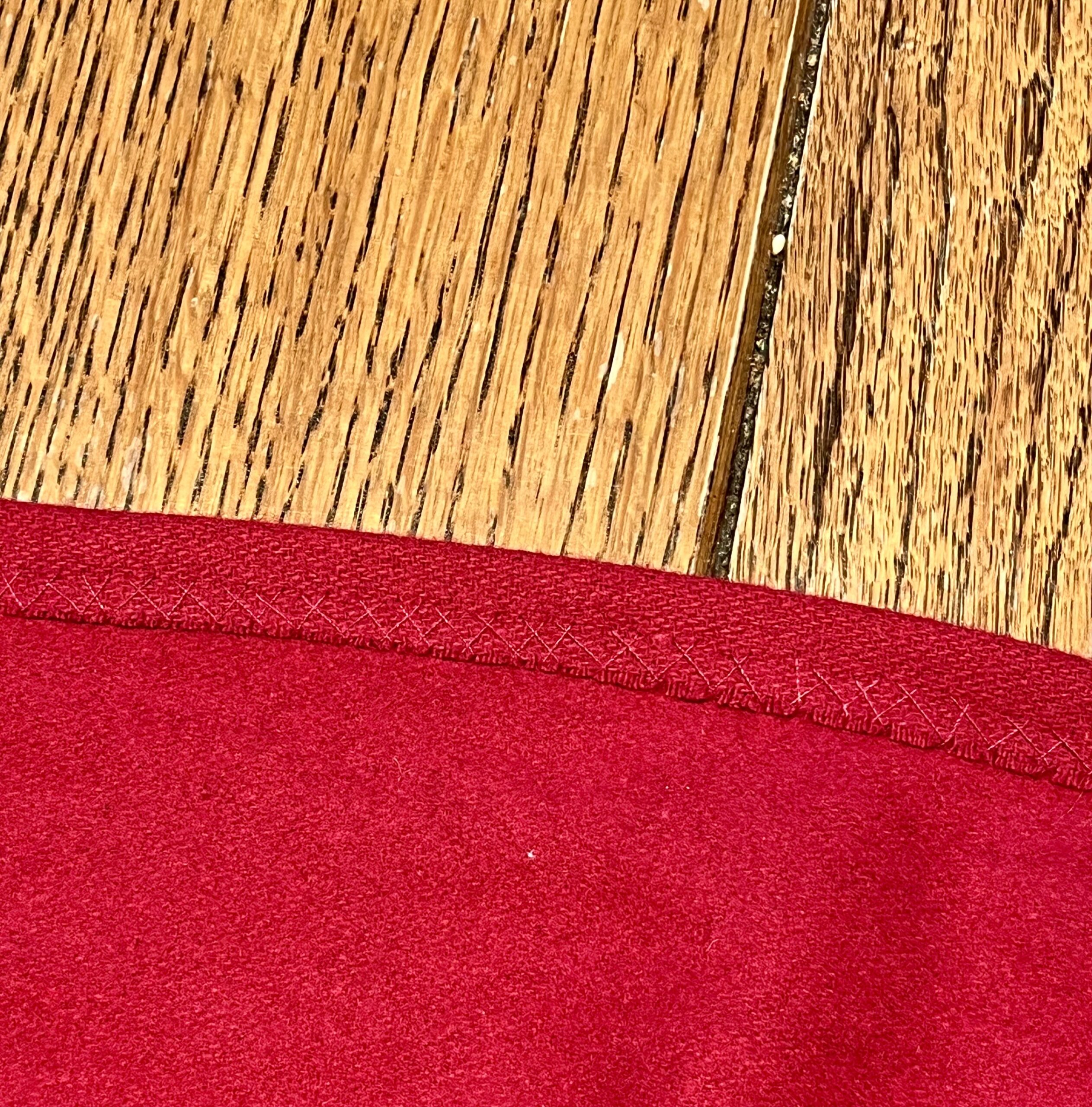 close-up of herringbone stitching on the hems of an 18th century cardinal cloak