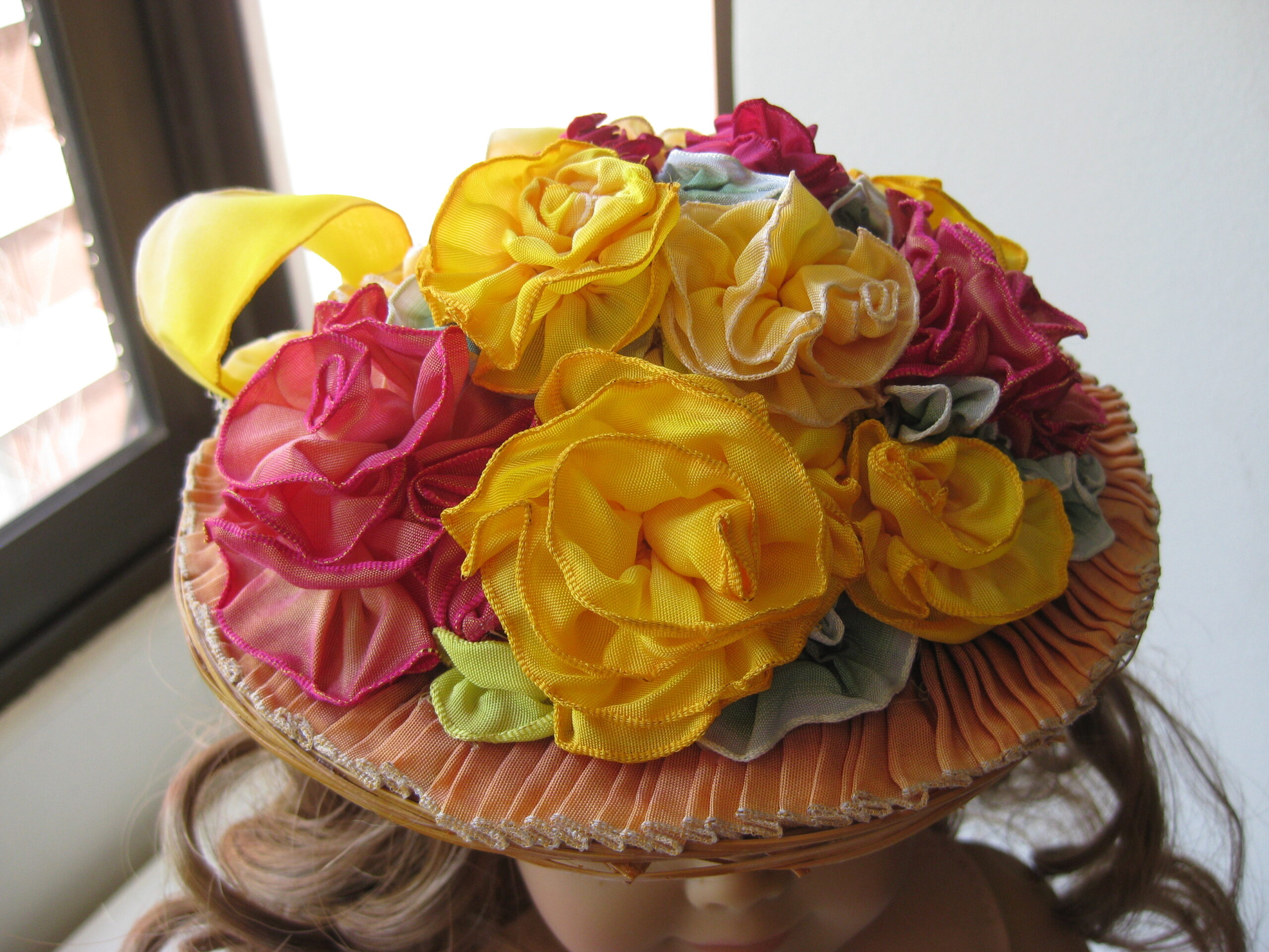An American Girl Doll Summer Hat covered in wired ribbon roses