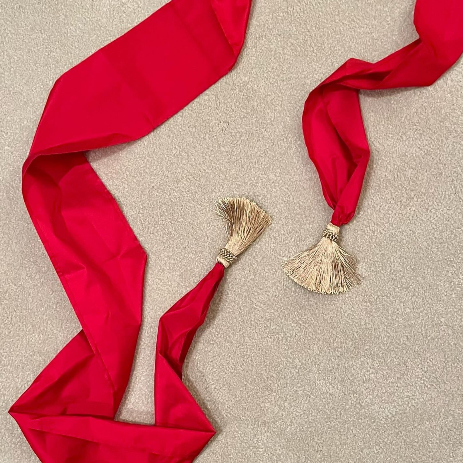 A red silk sash with gold tassels for a 1790s ensemble