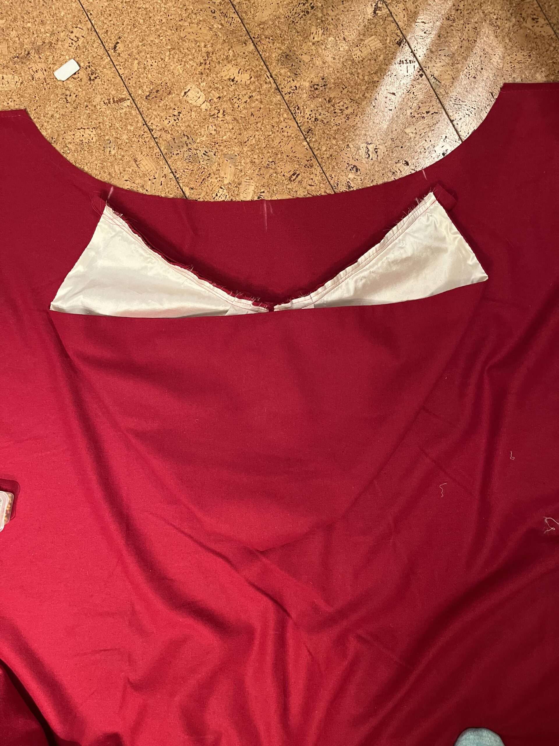 The hood of an 18th Century cardinal cloak is laid against the cloak neckhole to match center points
