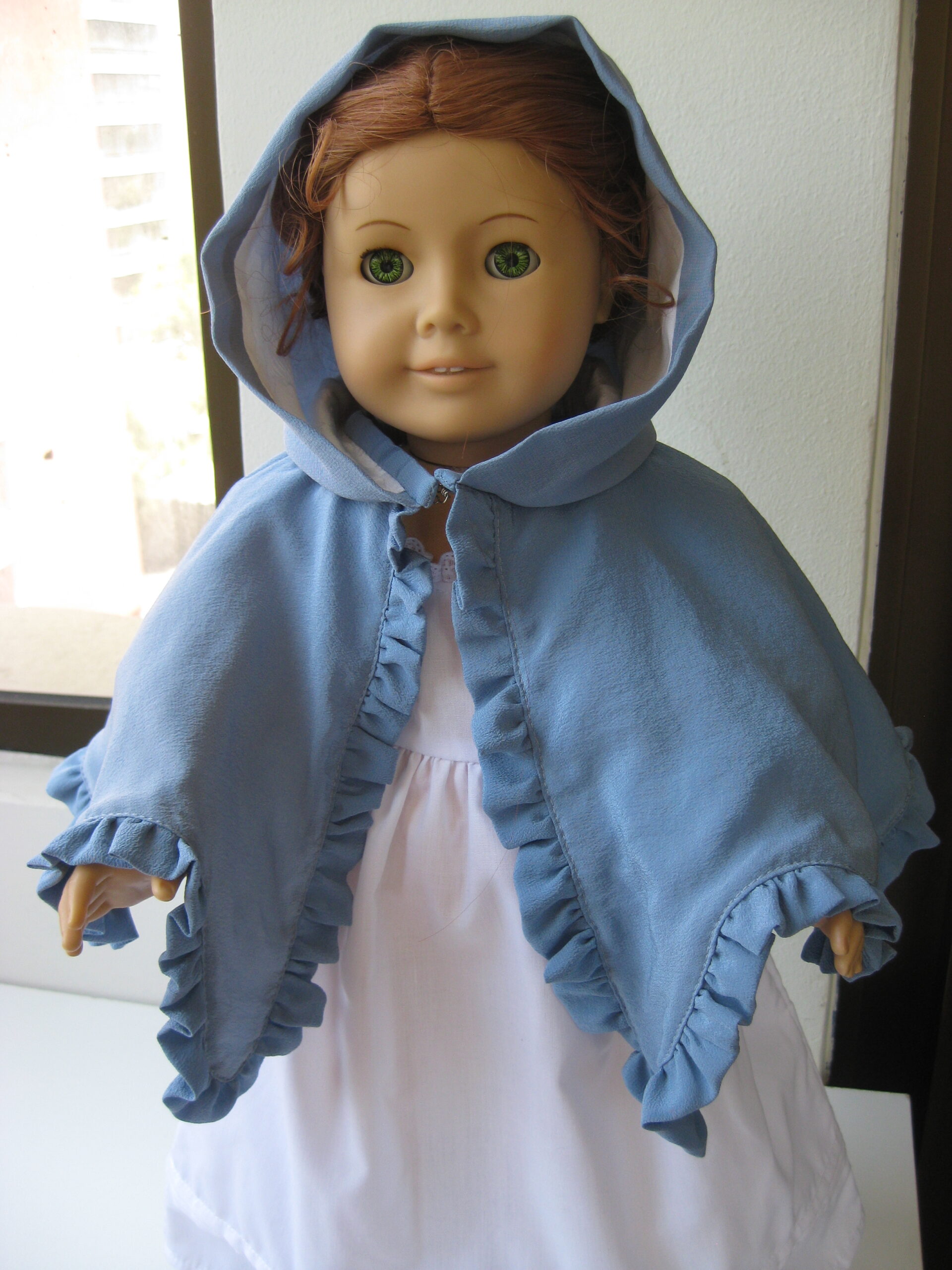 An American Girl doll wears an 18th Century blue silk Mantelet