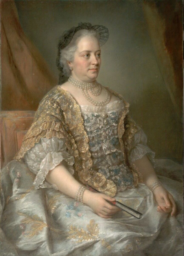 A woman sits sideways to the screen. She is wearing a18th century lace gown and a lace stomacher.