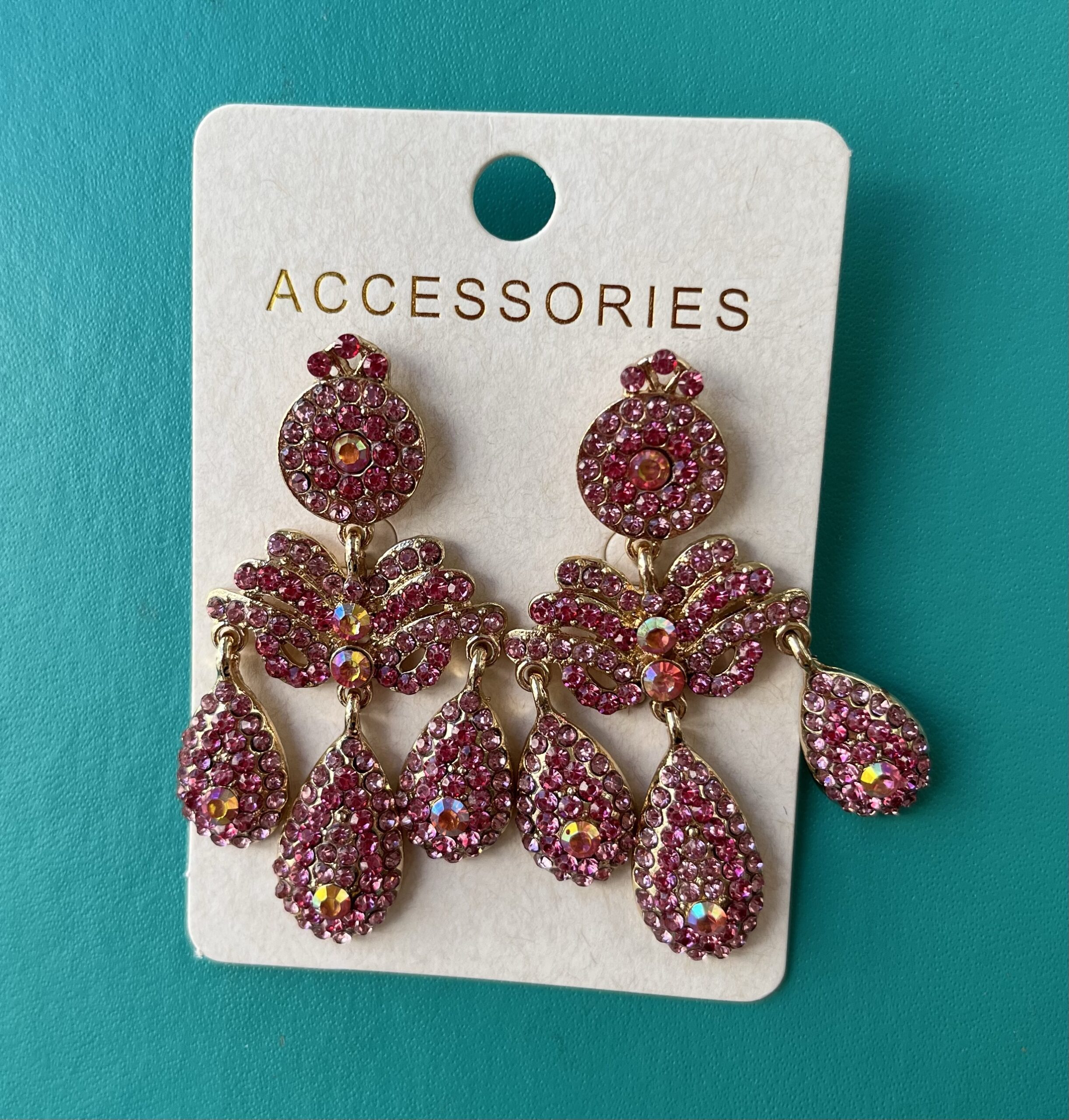 A pair girandole earrings set with neon pink rhinestones